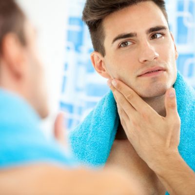 Young man looking in a mirror